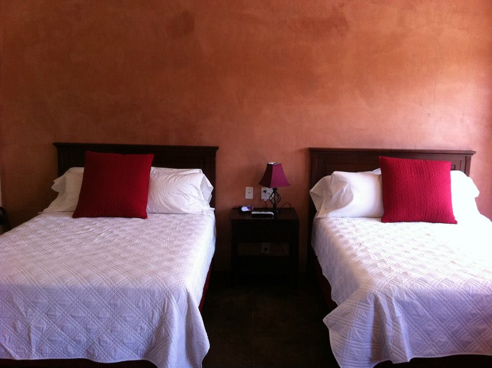 La Posada Pintada | Photo Gallery | 1 - Queen Room The queen room features two queen sized beds, a custom travertine showers, a sitting area, small kitchenette and a private patio.