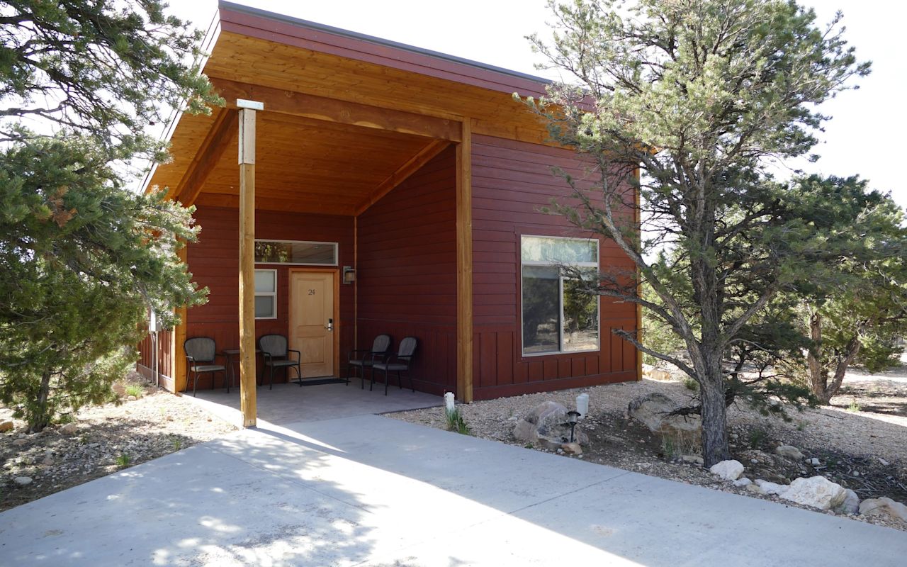 Stone Canyon Inn | Photo Gallery | 2 - Bungalows The private bungalows feature a large queen bed hideaway, a wide screen TV, and fireplace in the living room. In the master bedroom, enjoy a king bedroom and a private TV. The bathroom is decorated with clean ceramic tile.