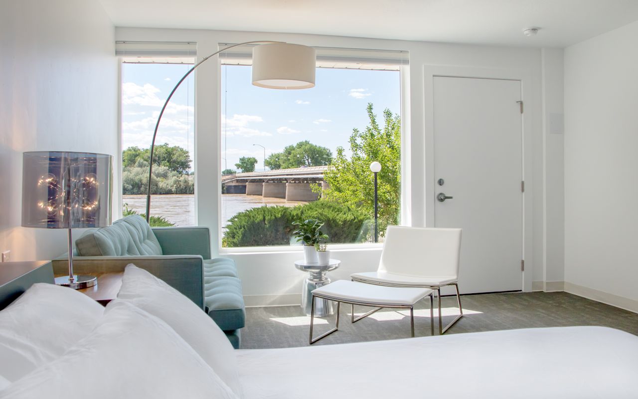 Skyfall Guestrooms | Photo Gallery | 1 - Book Cliff Guestroom Single Queen - The Book Cliffs Guestroom provides sweeping views of the Green River and the Book Cliffs. Relax and take in the brilliant pink and orange sunsets over this impressive geological feature.