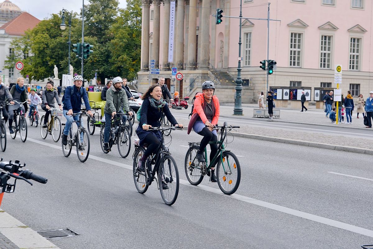 people riding bikes down a road