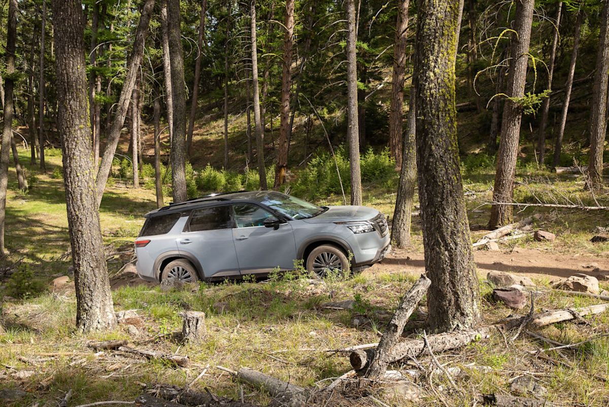 a silver Nissan Pathfinder near trees