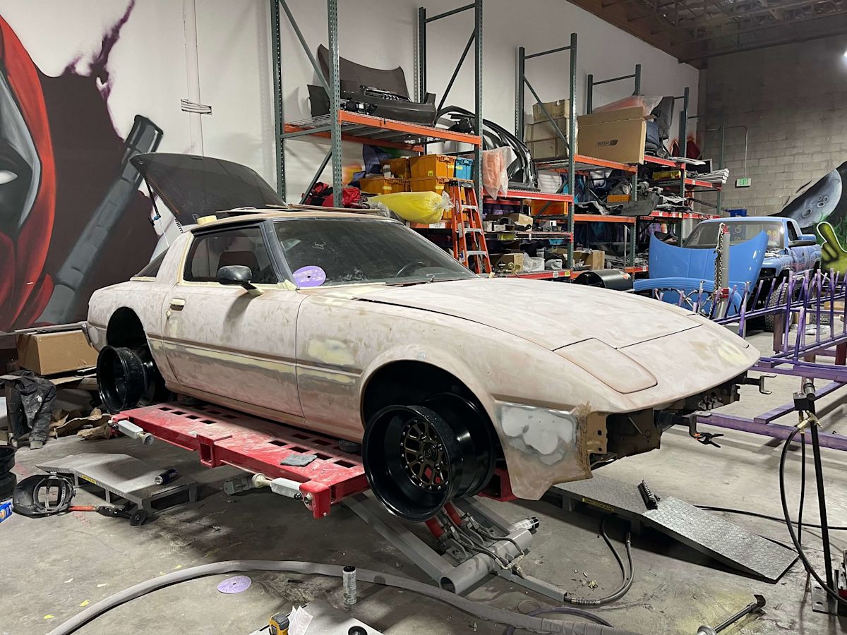 Wall's Mazda RX-7 sits in the body shop stripped of parts bore being rebuilt