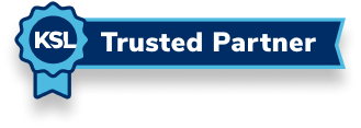 A blue ribbon with the letters "K-S-L" in the middle, and "Trusted Partner" in the banner to its side.