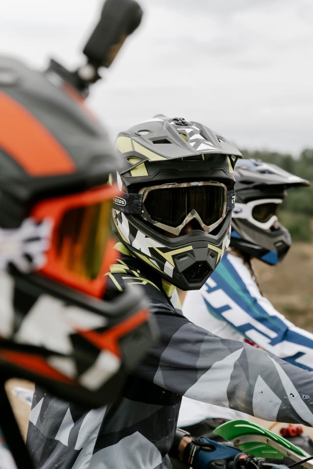 Riding dirt bikes with friends off-road or on the street.