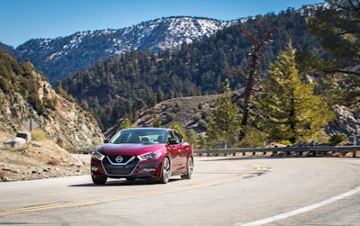 Nissan Maxima driving off into the sunset
