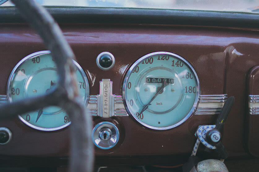 a dashboard and meter of a red car