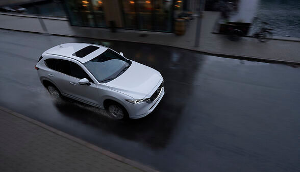 a 2022 CX-5 2.5 Turbo Signature driving in the rain