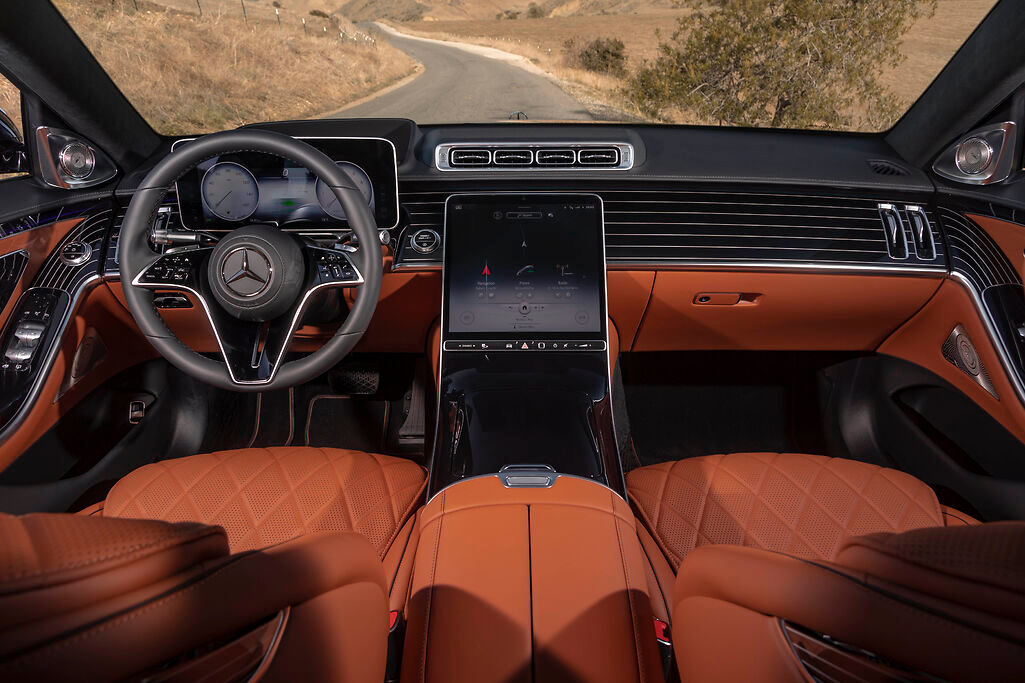 the wheel and dashboard of a black Mercedes-Benz S-Class