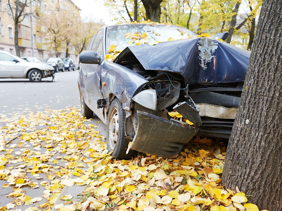 A blue car veered off the road and hit a tree