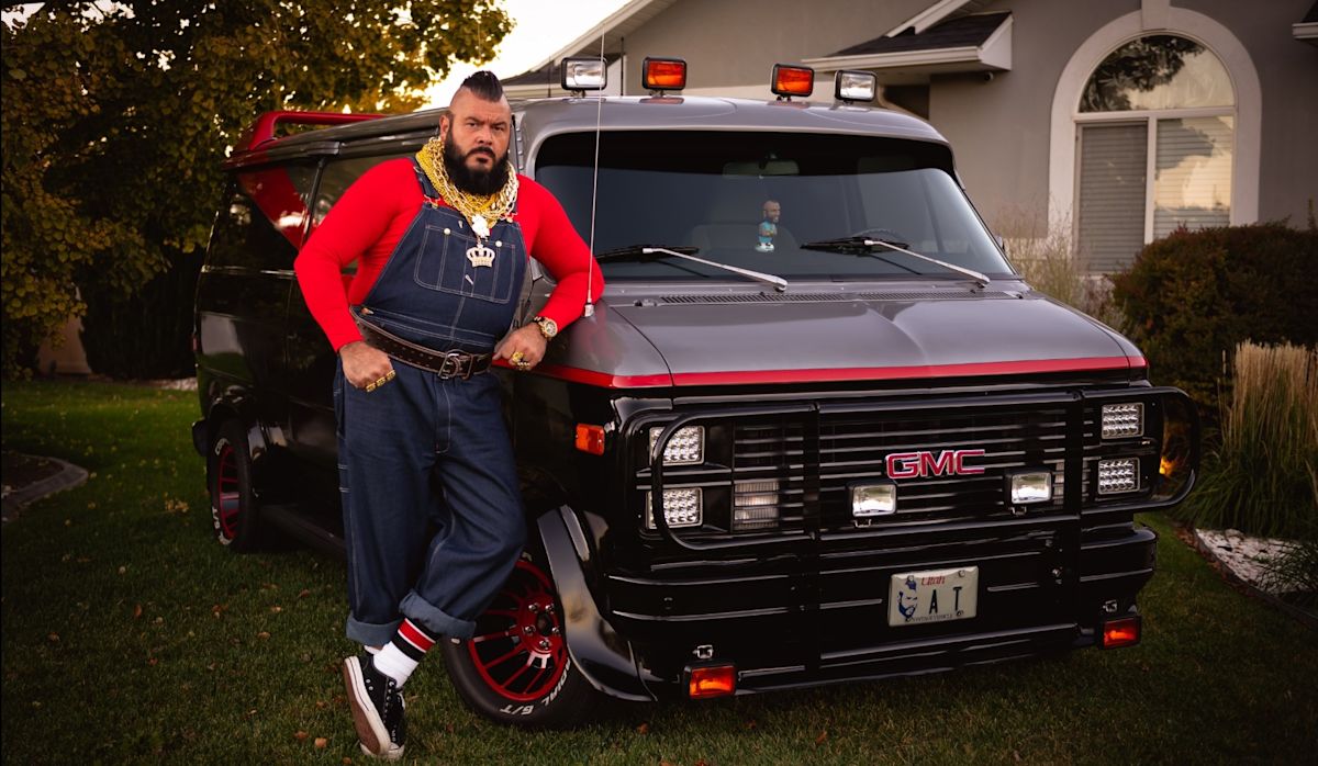 Johnny, dressed in overalls and a red shirt to look like Mr. T, poses next to his completed A-Team Van