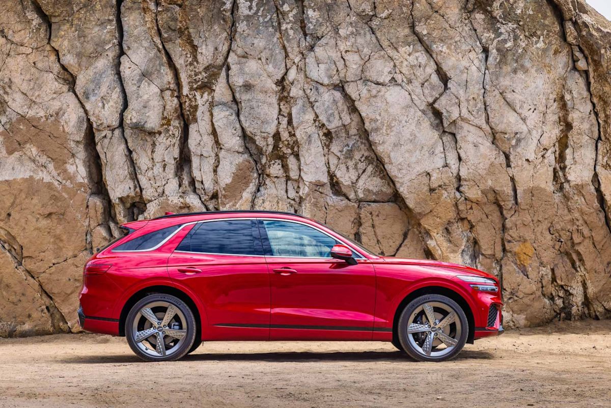 the side profile of a red Genesis GV70 