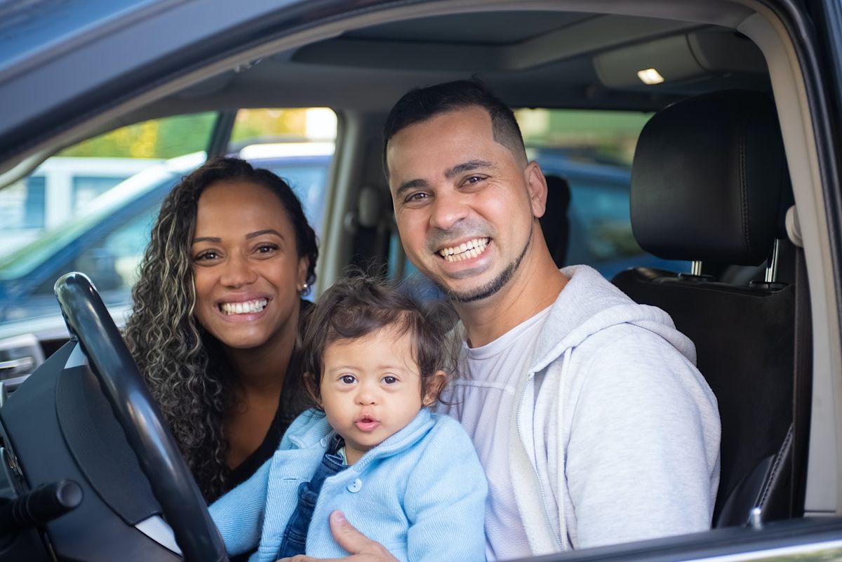 a young family sitting in a sedan