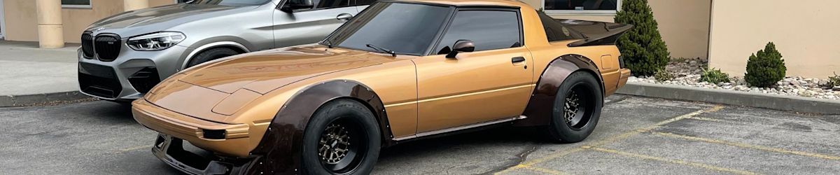 A Mazda RX-7 gifted to a Make-a-Wish patient sits on display in a parking lot