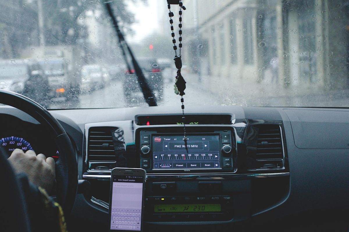 a man driving an awd car in the rain