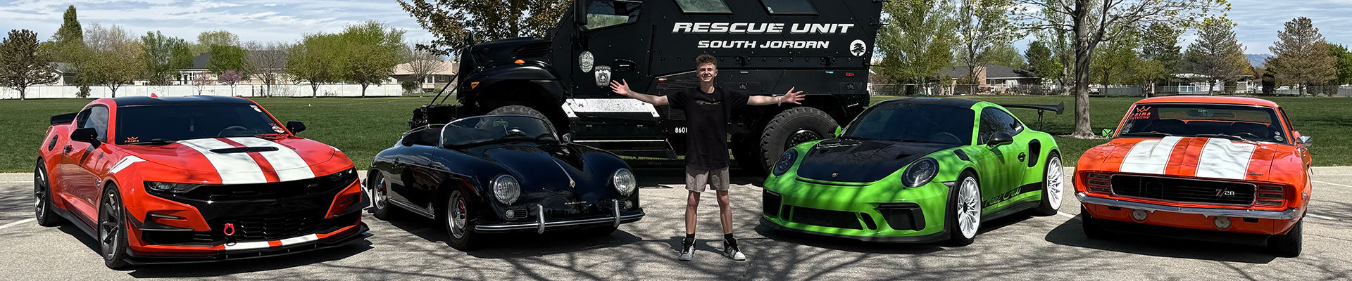 Sports cars and an emergency vehicle flank Utah teenager Abel Bringhurst at his annual car show to benefit first responders