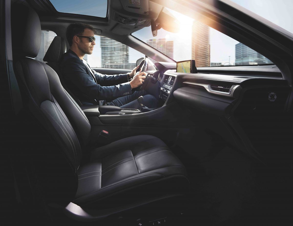 a man sitting in the front seat of a 2022 Lexus RX 450h