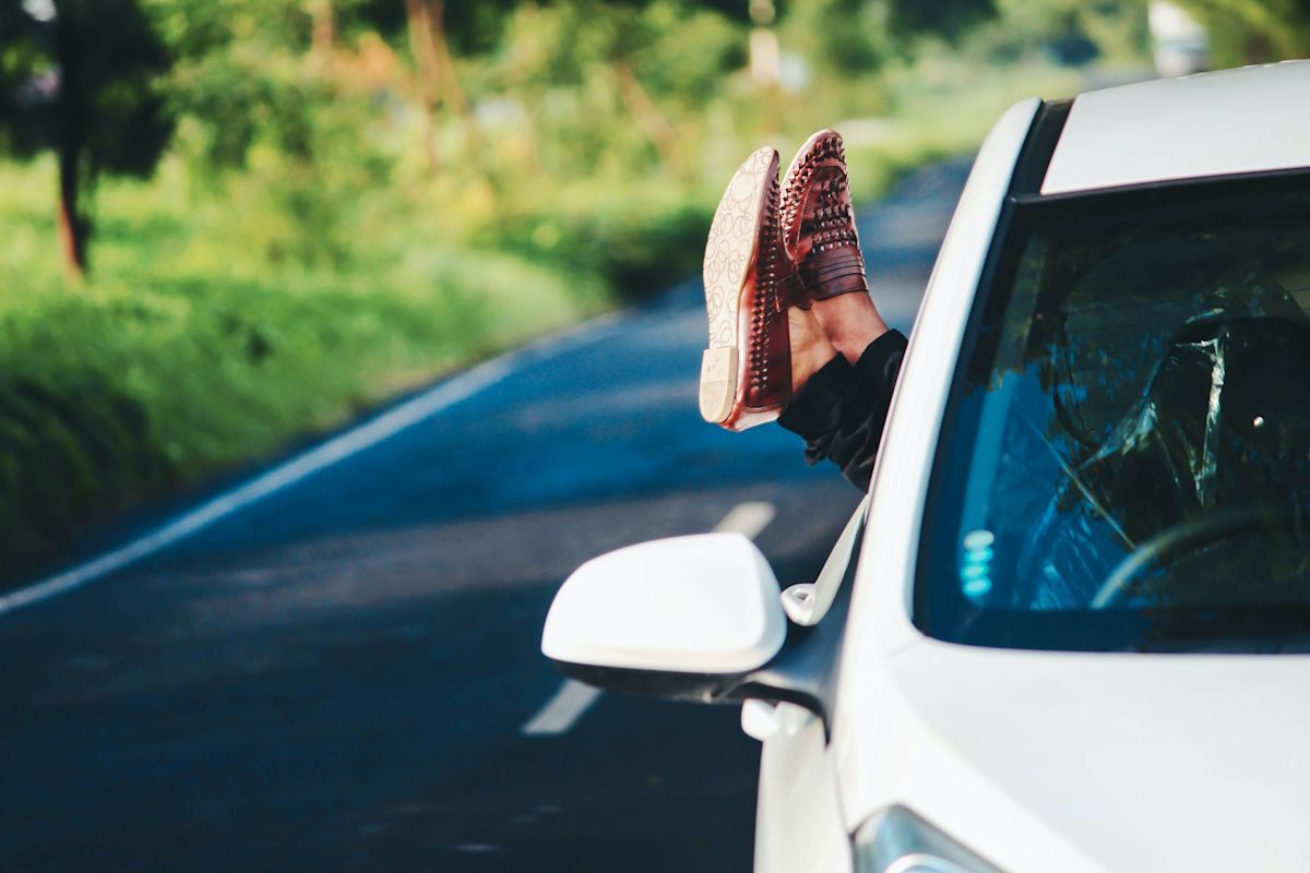 a girl driving a white car