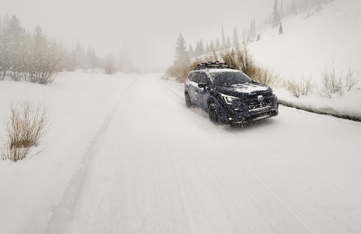Snow falls on a 2024 Subaru Ascent with Cosmic Blue Pearl paint