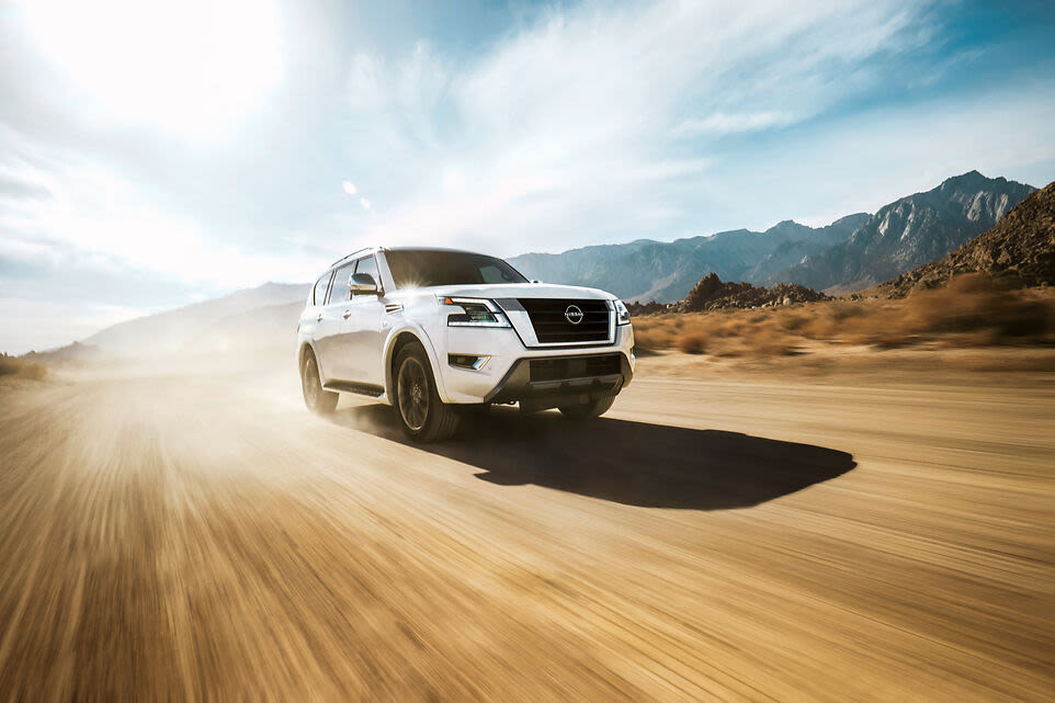 a white 2022 Nissan Armada driving down a road