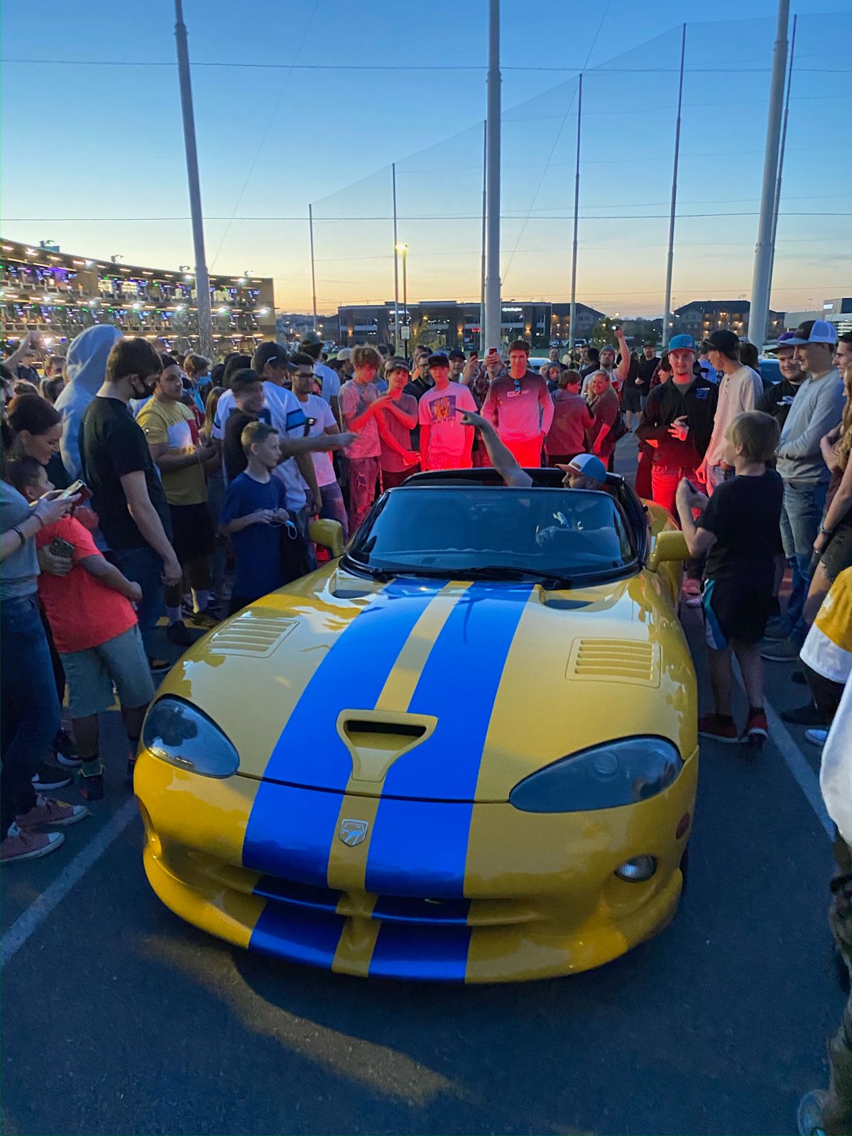 The Burlacher sits in his iconic vehicle as fans gather round to take a look.