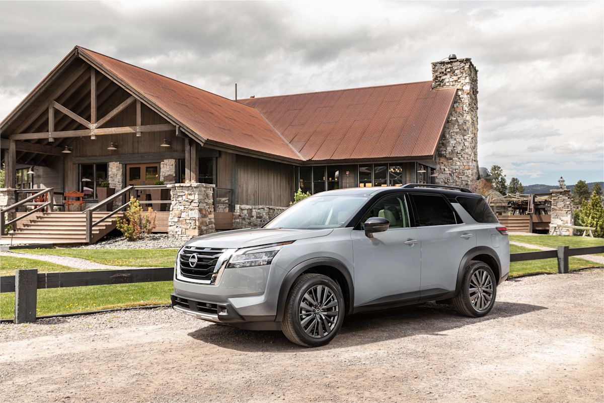 a silver Nissan Pathfinder in front of a house