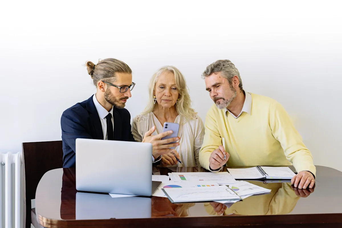 two men and a woman discussing insurance benefits
